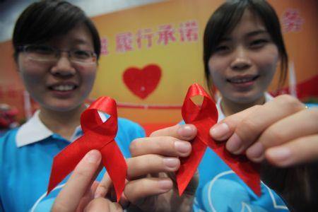 Volunteers&nbsp;show&nbsp;red&nbsp;ribbons&nbsp;during&nbsp;an&nbsp;AIDS&nbsp;awareness&nbsp;activity&nbsp;in&nbsp;Beijing,&nbsp;capital&nbsp;of&nbsp;China,&nbsp;Nov.&nbsp;29,&nbsp;2009.&nbsp;AIDS&nbsp;protection&nbsp;achievement&nbsp;show,&nbsp;AIDS&nbsp;protection&nbsp;volunteer&nbsp;recruitment&nbsp;and&nbsp;AIDS&nbsp;awareness&nbsp;publicity&nbsp;activity&nbsp;will&nbsp;be&nbsp;held&nbsp;during&nbsp;the&nbsp;AIDS&nbsp;protection&nbsp;volunteer&nbsp;week,&nbsp;which&nbsp;is&nbsp;from&nbsp;Nov.&nbsp;29&nbsp;to&nbsp;Dec.&nbsp;5.&nbsp;(Xinhua/Chen&nbsp;Xiaogen)
