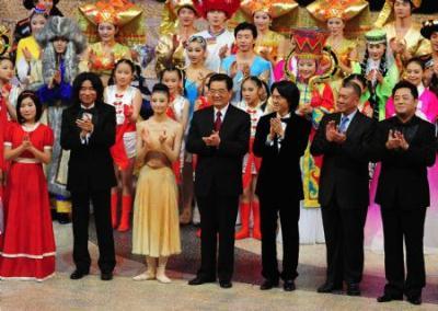 Chinese President Hu Jintao (4th L, front row) joins the chorus to sing the song 