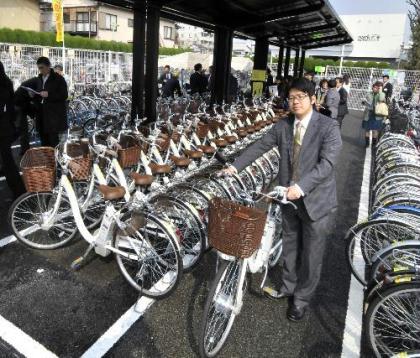 People rent power assisted bicycles at a "solar parking lot", a new initiative set up by Tokyo's Setagaya ward with Japanese electronics company Sanyo, near a railway station in Tokyo, on March 16. (Xinhua/AFP Photo)