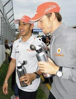 McLaren Formula One teammates Lewis Hamilton and Jenson Button of Britain chat as they leave the track following the drivers parade at the Australian Formula One Grand Prix in Melbourne,Sunday, March 28, 2010. [Photo/Agencies]