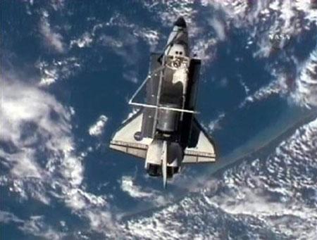The space shuttle Discovery undocks from the International Space Station Saturday and heads home after a mission to install a new ammonia tank and deliver experiments and other gear. (Xinhua/Reuters Photo)