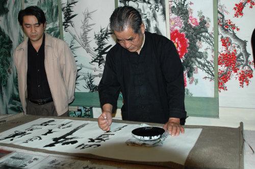 Hu Wenfu writes calligraphy using his fist instead of a brush.