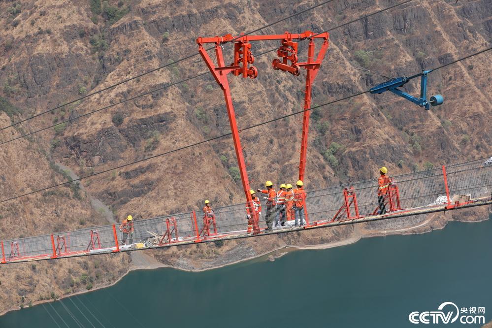 金沙江上搭起"超级脚手架 世界在建最大跨径山区峡谷悬索桥猫道贯通