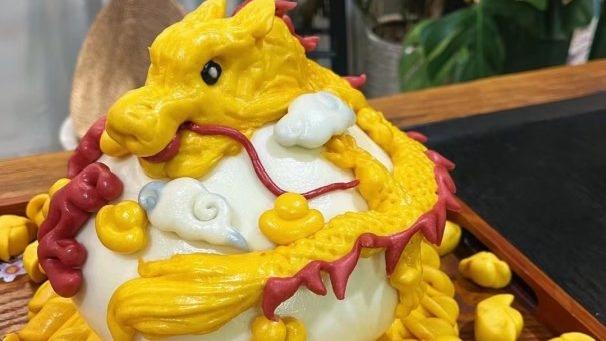 People make exquisitely-decorated 'dragon' shaped steamed buns during Spring Festival