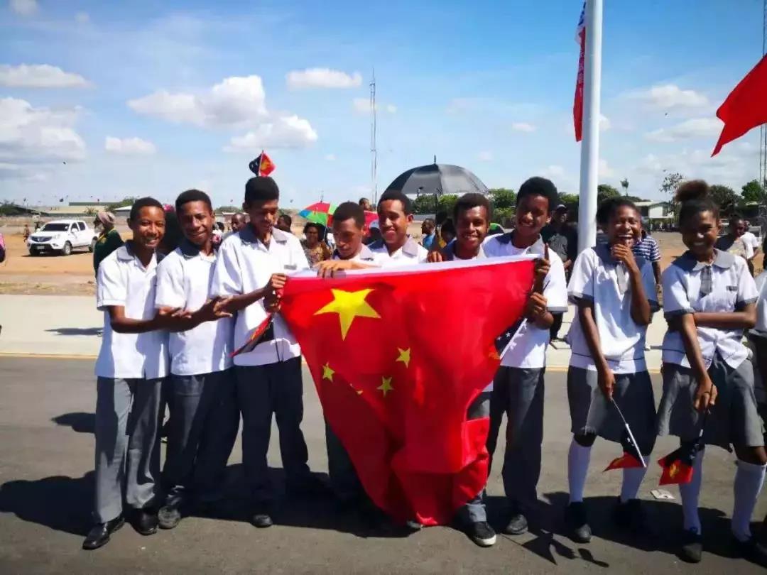 独立大道上手持中国国旗的巴新男孩。（央视记者魏建拍摄）