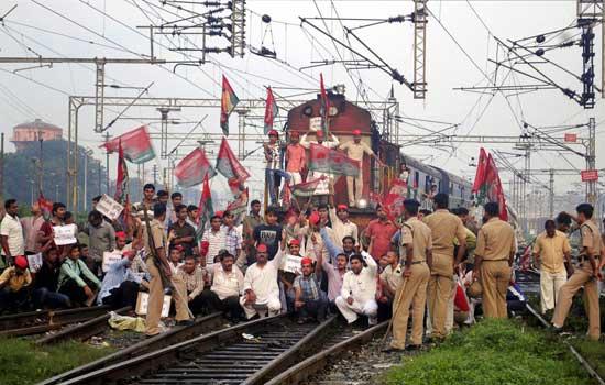 Samajwadi Party activists block a train during a strike in Allahabad, India, Thursday, Sept. 20, 2012.