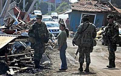 Rescue crews remove a dead body from a destroyed building in Concepcion, Chile, Monday, March. 1, 2010. An 8.8-magnitude earthquake struck central Chile early Saturday. (AP Photo/ Aliosha Marquez)