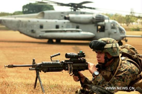 FILE PHOTO: An infantryman provides cover fire for a helicopter during a mock helo raid of Exercise Cobra Gold 2011 in Samesan, Thailand, on Feb. 13, 2011. Cobra Gold 2011 marks the 30th anniversary of the exercise, which focuses on basic military skills training, staff planning and humanitarian and civic assistance projects.(Xinhua/Pr. Photo Cobra Gold 2011)<br>