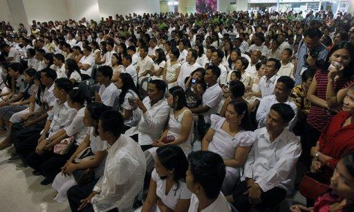 Couples take part in a mass wedding ceremony as part of a Valentine's Day