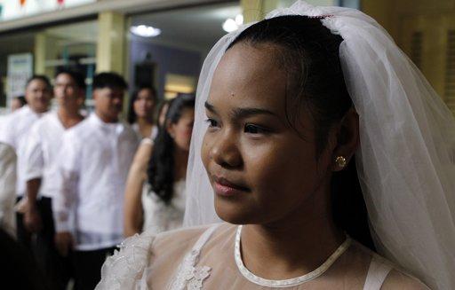  as she waits for her groom to register in a mass wedding ceremony as