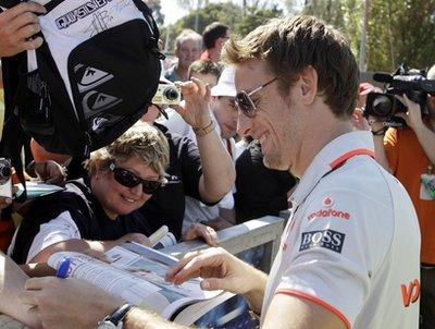 McLaren Formula One driver Jenson Button of Britain signs autographs as he arrives at the Albert Park Circuit in preparation for the Australian Formula One Grand Prix in Melbourne,Thursday, March 25, 2010. The seasons second race will be held here on Sunday March 28.(AP Photo/Rob Griffith)