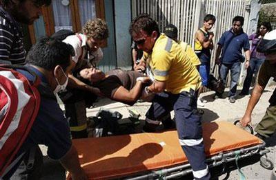 A woman, victim of a panic attack after a tsunami alert, is loaded on a stretcher in Constitucion, Chile, Wednesday, March 3, 2010. A 8.8-magnitude earthquake hit Chile early Saturday. (AP Photo/Fernando Vergara)