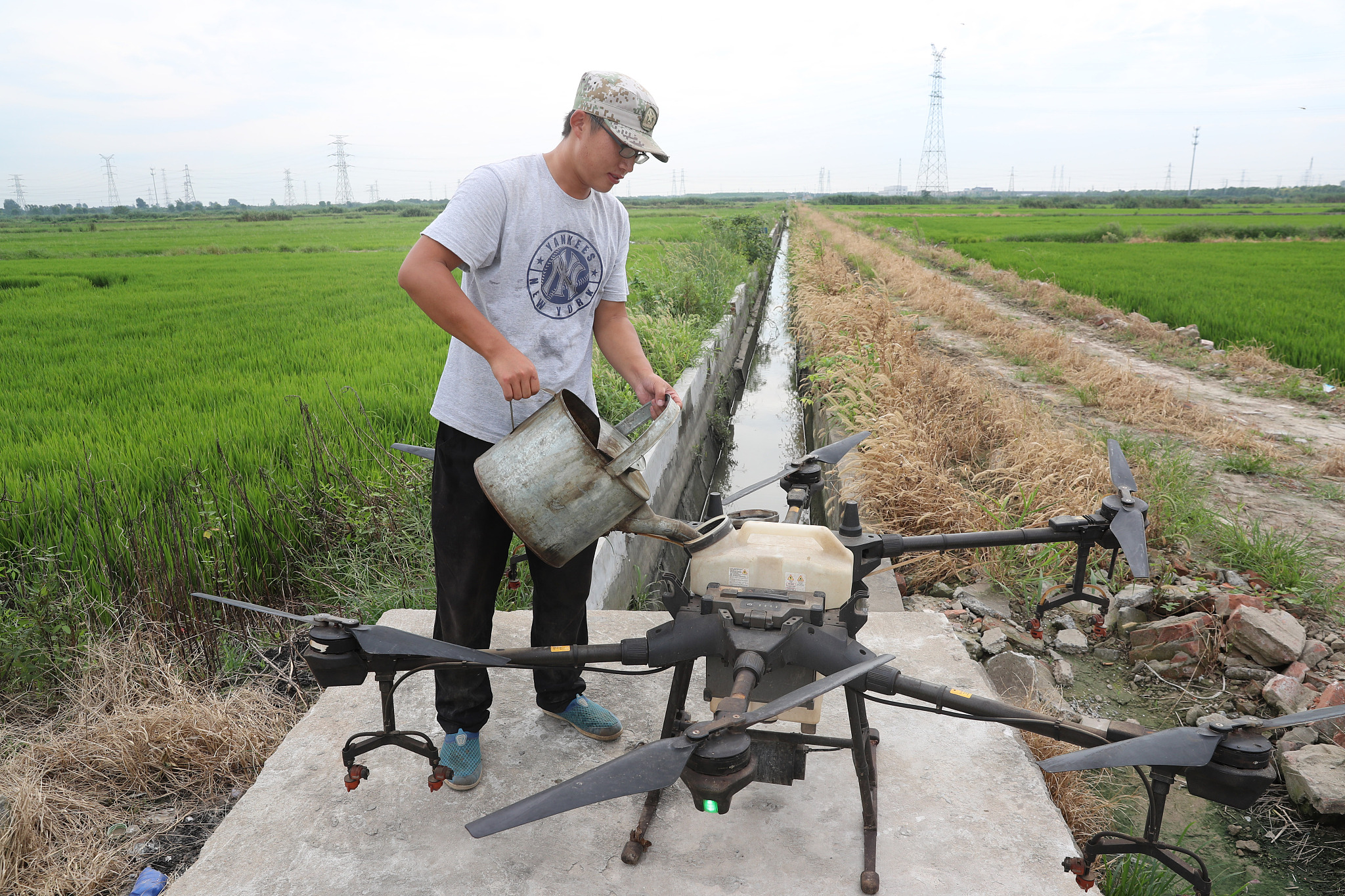 A farmer uses a drone for pesticides spraying in Nantong, Jiangsu Province, August 7, 2020.