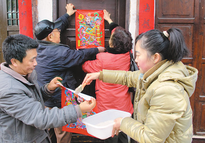 四川阆中古城居户在贴门神.王玉贵 摄