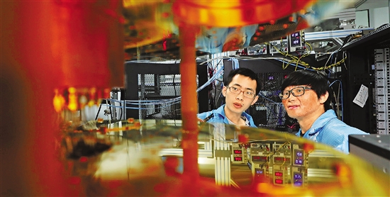 论文的其中两位共同第一作者宋超（左）和许凯在量子计算实验平台边。 卢绍庆 摄