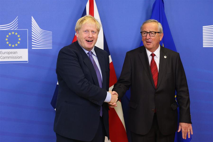 British Prime Minister Boris Johnson (L) shakes hands with President of the European Commission Jean-Claude Juncker during a press conference at the European Commission headquarters in Brussels, Belgium, Oct. 17, 2019. The European Union and Britain have reached a new Brexit deal, Jean-Claude Juncker said Thursday on his twitter account. (Xinhua/Zheng Huansong)