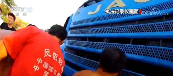 事故致一人卷入车底 附近群众出手帮助民警抬车救人