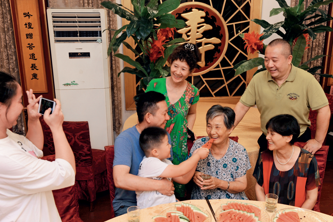 　　▲ 2019年9月13日，浙江南浔久安老年城餐厅， 84岁的沈学安老人（前右二）和前来看望她的亲人欢聚。谭进摄