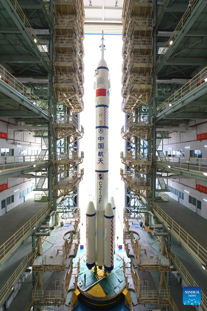 The combination of the Shenzhou-15 crewed spaceship and a Long March-2F carrier rocket is to be transferred to the launching area in Jiuquan Satellite Launch Center in northwest China, Nov. 21, 2022. (Photo by Wang Jiangbo/Xinhua)