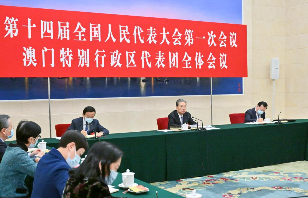 Zhao Leji, a member of the Standing Committee of the Political Bureau of the Communist Party of China (CPC) Central Committee, joins deputies from the Macao Special Administrative Region (SAR) in a group deliberation at the first session of the 14th National People’s Congress (NPC) in Beijing, capital of China, March 7, 2023. (Xinhua/Gao Jie)