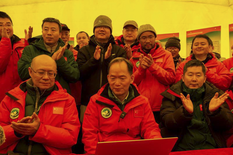 Scientific research members applause as they receive data from the 8,830-meter weather station at the mountaineering base camp in the Qomolangma National Nature Reserve in southwest China’s Tibet Autonomous Region, May 23, 2023. (Photo by Tenzin Norbu/Xinhua)