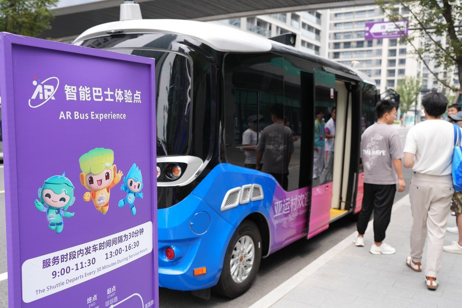 Journalists experience an AR Bus at the Hangzhou Asian Games Village on Sept. 12, 2023. (Xinhua/Weng Xinyang)