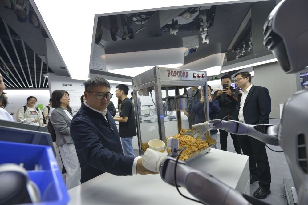 2025年10月29日，在广东深圳越疆科技有限公司，机器人为记者装爆米花。新华社记者 刘力航 摄