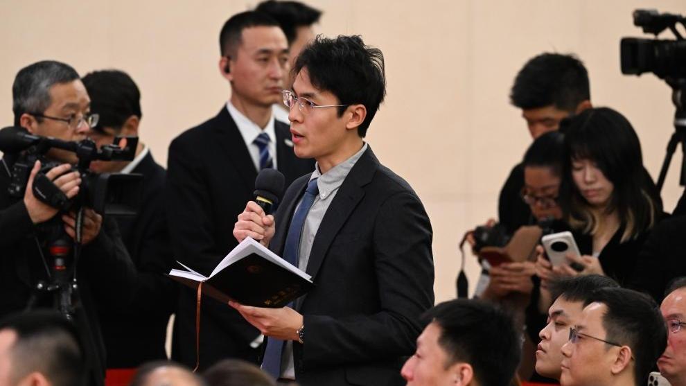 A journalist asks a question at a press conference attended by Chinese Foreign Minister Wang Yi on the sidelines of the fourth session of the 14th National People
